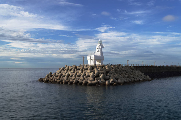 rear view of white horse shaped lighthouse and pier  - Photo, Image