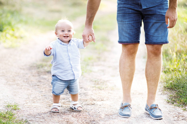 Young father walks with his cute little boy in a forest. Father's Day - Foto, Imagem