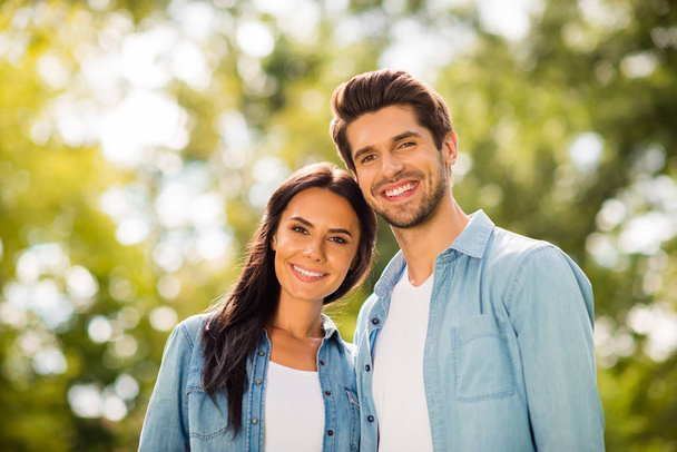 Photo of overjoyed pair attending green summer park wear denim outfit - Photo, image