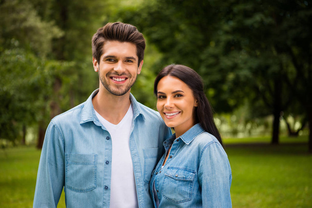 Portrait of charming people with beaming smile standing outdoors wearing denim jeans shirt - Foto, Imagem