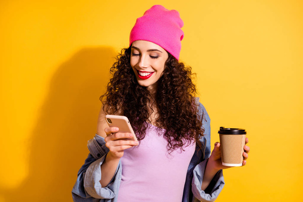 Photo of amazing lady searching in smart phone nice song for coffee break wear casual cool outfit isolated yellow color background - Foto, afbeelding