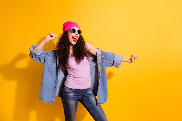 Portrait of funny funky woman dance on party have exciting holidays wear denim jeans modern clothes good look isolated over yellow color background - Foto, Imagem