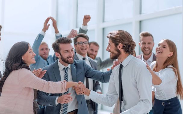 счастливая команда бизнесменов поздравляет молодых деловых партнеров
 - Фото, изображение