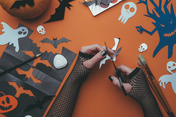 Photo of halloween backgrounds with paper ghosts, pumpkin, skulls, human hands - Photo, Image
