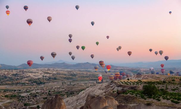 Interesting rocky terrain and a lot of airy multicolored balls in the air. Turkey. Cappadocia. - Photo, Image