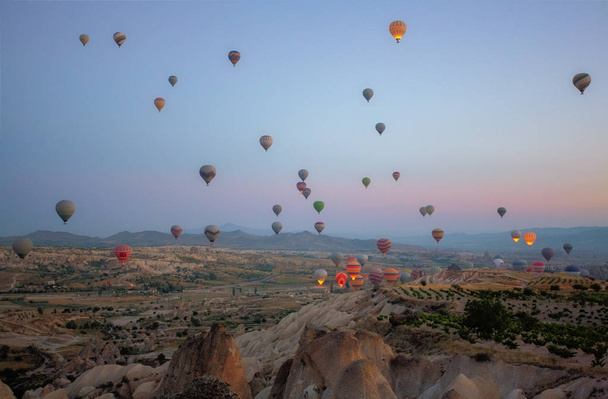 Interesting rocky terrain and a lot of airy multicolored balls in the air. Turkey. Cappadocia. - Photo, Image