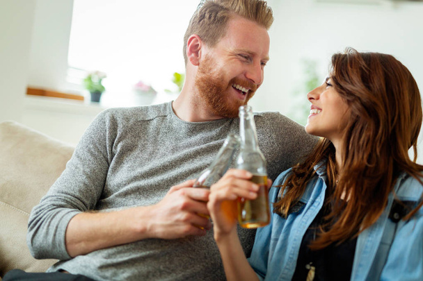 Cute young couple drinking and celebrating together at home - Photo, Image