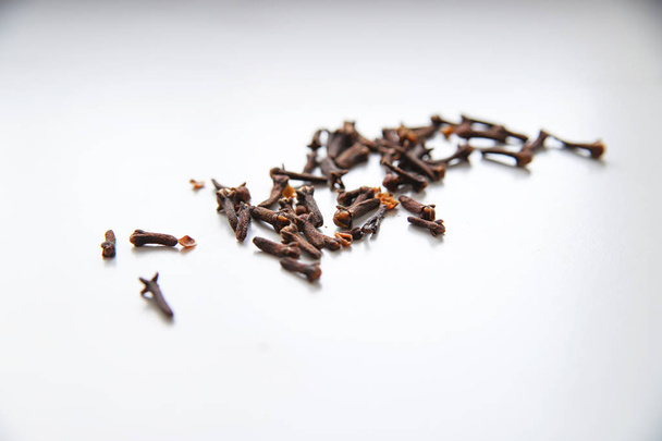 Dried cloves on grey marble background. Spice for hot tea, winter drinks and food. Close up and top view - Photo, image