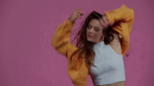 stylish girl dancing isolated on purple  - Felvétel, videó