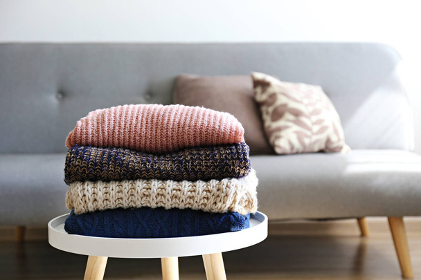 Pile of knitted sweaters of different colors and patterns perfectly stacked. - Foto, immagini