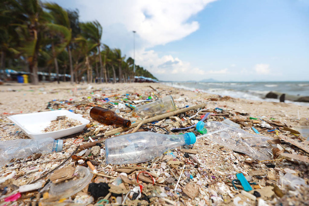 Bilder von schmutzigem Strand voller Plastikverschmutzung, Müll und Abfall auf sandigem Boden - Foto, Bild