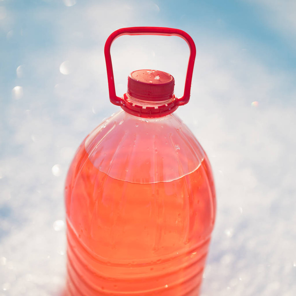 bottle with non-freezing windshield washer fluid, snow background - Photo, Image