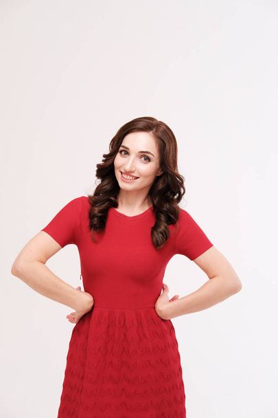 studio portrait of woman in red dress on plain background - 写真・画像