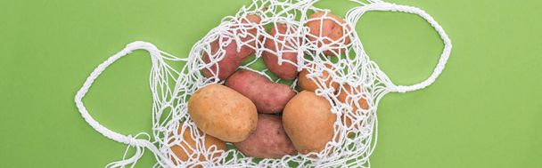 top view of potato in eco friendly bag isolated on green - Zdjęcie, obraz