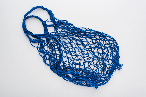 top view of empty blue eco friendly string bag isolated on white - Fotografie, Obrázek