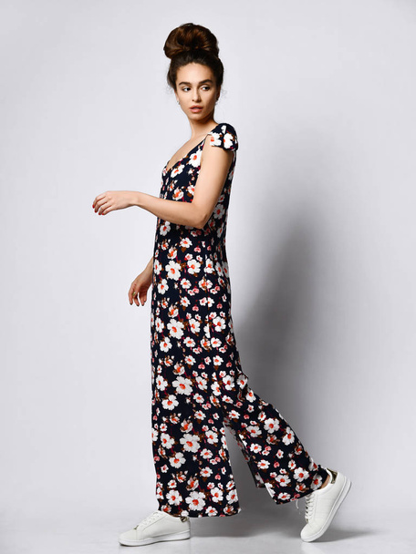 Woman in Long Floral Dress in Fashion Store - Portrait of girl in a clothes shop in a maxi summer dress - Foto, Imagen