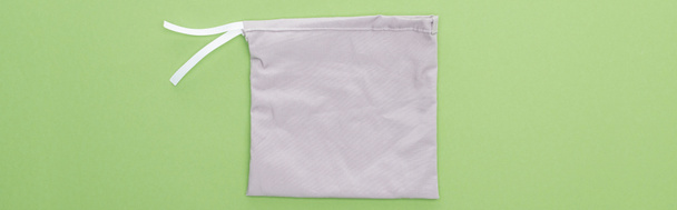 top view of eco friendly grey bag isolated on green, panoramic shot - Φωτογραφία, εικόνα