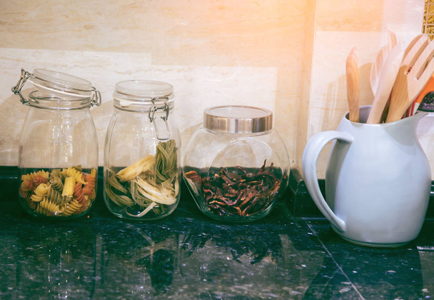 Spices and raw materials for cooking are in the elegant kitchen. - Foto, Imagen