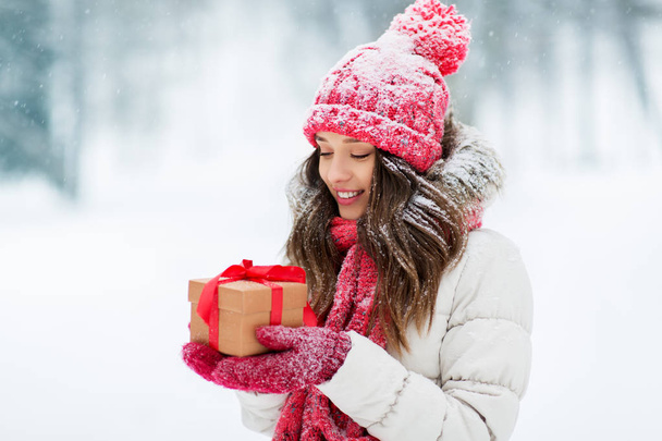 happy young woman with christmas gift in winter - Fotó, kép