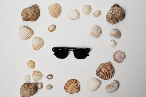 shells and sunglasses. the concept of the sea - Fotó, kép