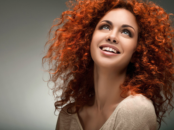 Red Hair. Beautiful Woman with Curly Long Hair and Sunglases - 写真・画像
