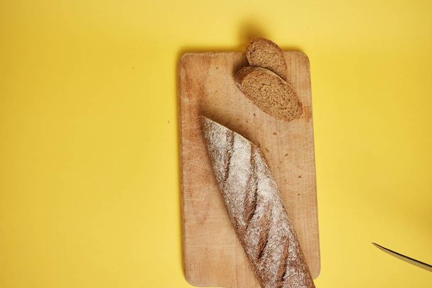 Fresh tasty rye bread on wooden board - Фото, зображення