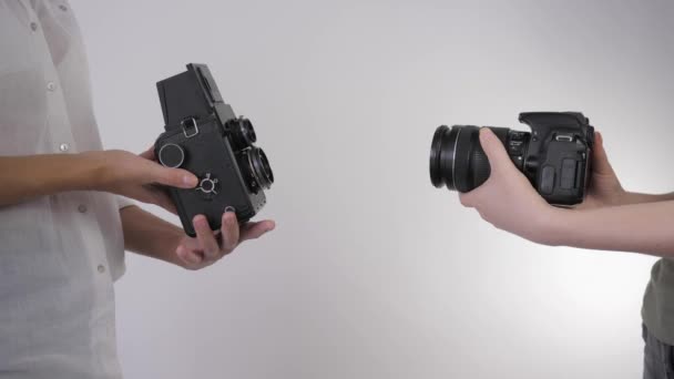 vintage photo, professional photo studio compares old film camera with modern digital camera - Footage, Video