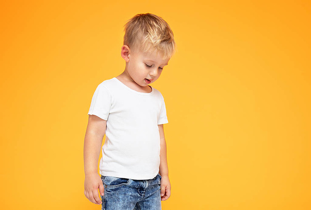 Fashionable little boy posing in jeans. - Foto, Imagen