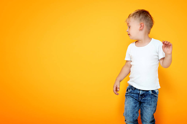 Fashionable little boy posing in jeans. - Фото, изображение