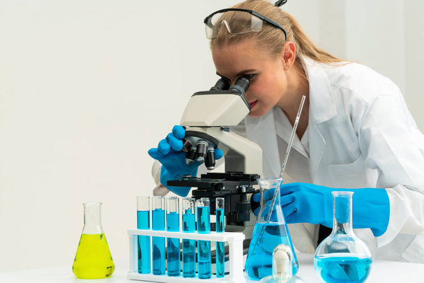 Woman scientist working in chemist laboratory. - Фото, изображение