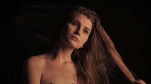 Portrait of sensual woman on black background - Filmati, video