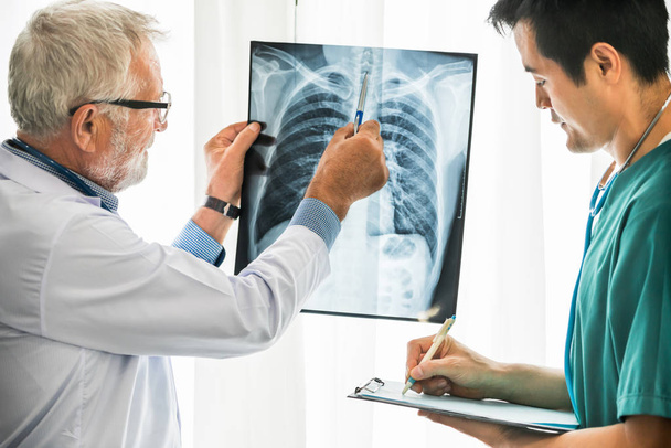 Doctors working with x ray film of patient chest. - Zdjęcie, obraz