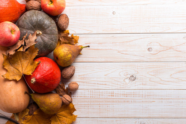 Different vegetables, pumpkins, apples, pears, nuts and dry yellow leaves on a white wooden background, copy space. Harvest concept. - Fotoğraf, Görsel