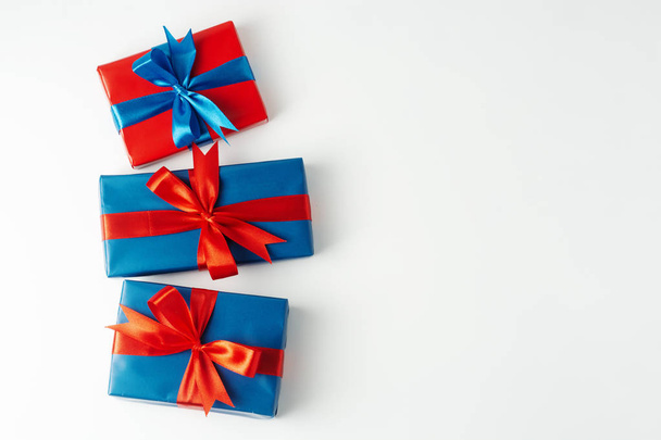 Blue and red three gift boxes isolated over white background. Christmas, party or birthday concept. Copy space. - Photo, Image