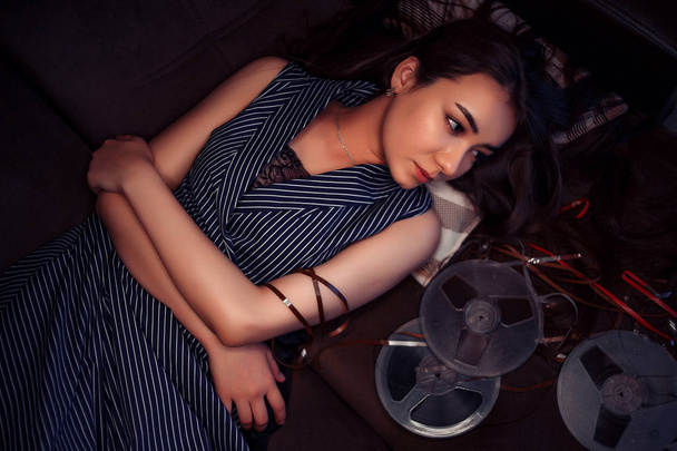 portrait of a young Asian girl in a blue striped dress lying on  - Photo, Image