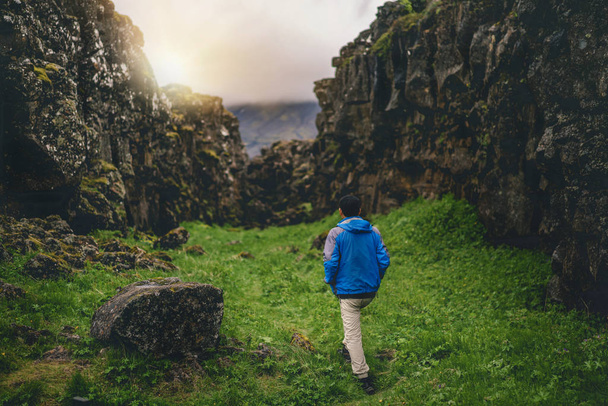 Man traveler hiking across Iceland landscape. - Photo, image