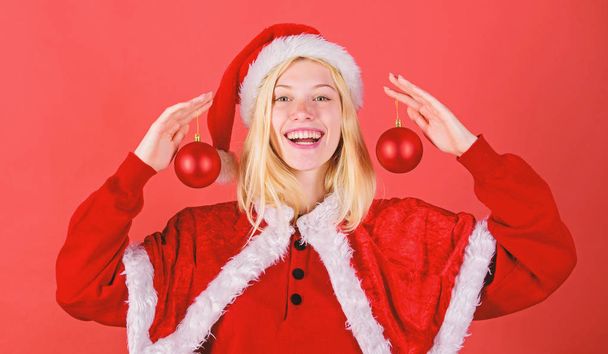 Girl happy wear santa costume celebrate christmas hold ball decor. Happy holidays concept. Favorite time year christmas. Merry christmas. Enjoy celebration with proper costume and decoration - Foto, Bild
