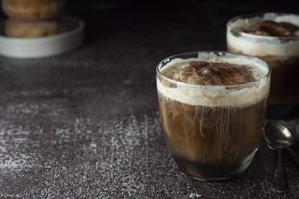 Affogato coffee with ice cream on a glass cup, dark, black background. Copy space. - 写真・画像