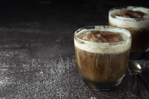 Affogato coffee with ice cream on a glass cup, dark, black background. Copy space. - Foto, Bild