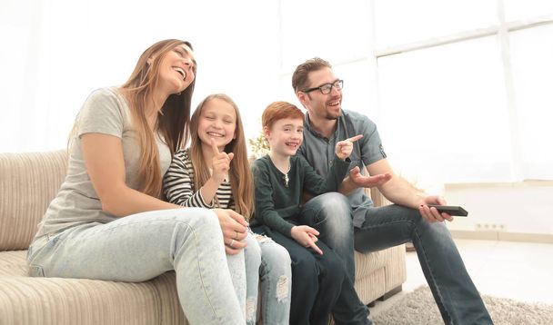 happy family watching their favorite TV show. - Valokuva, kuva