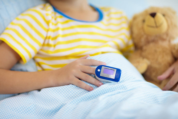 Pulse oximeter. Sick boy with asthma. Ill child. - Photo, Image