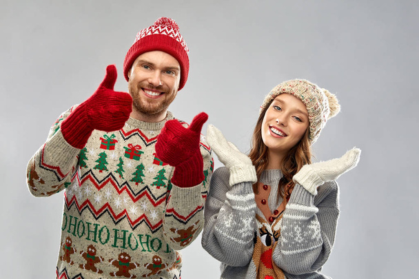 happy couple at christmas ugly sweater party - Фото, зображення