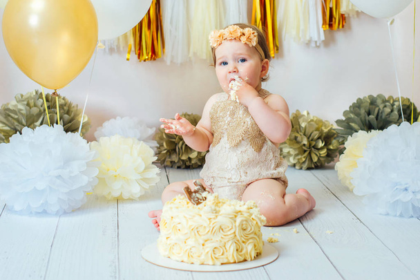 kleines Mädchen isst Kuchen auf ihrer ersten Geburtstagsparty - Foto, Bild
