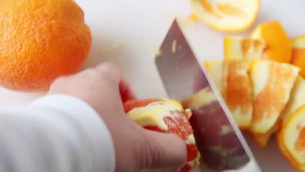 Removing pith from orange, then cutting it into round slices - Footage, Video