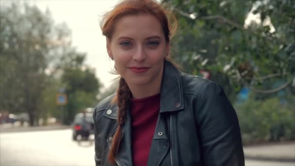Portrait of an attractive smiling young woman with glasses close-up face of a happy woman with long red hair in a good mood, positive emotions. - Filmmaterial, Video
