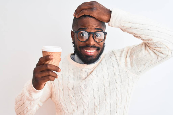African american man with braids drinking take away coffee over isolated white background stressed with hand on head, shocked with shame and surprise face, angry and frustrated. Fear and upset for mistake. - Фото, зображення