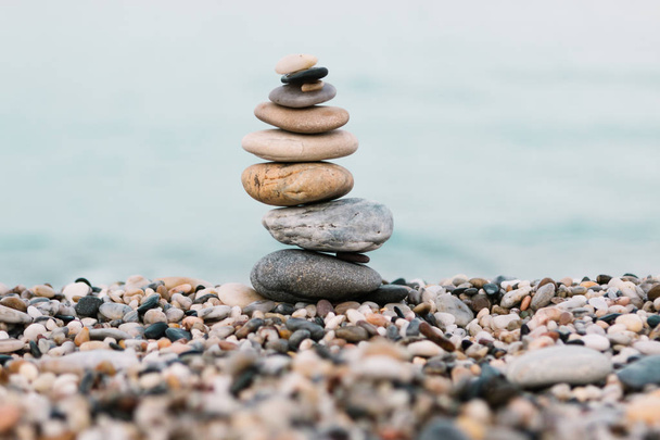 Stack of pebble Stones on ocean background. Peaceful and calm concept - Photo, Image