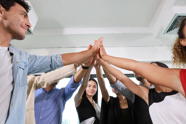 Close up of multiethnic business people stacking hands together meaning of teamwork concept - Photo, Image