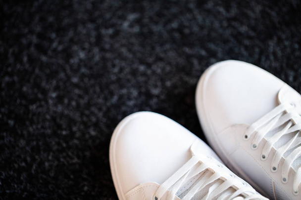 Coppia di nuove eleganti sneakers bianche sul pavimento di casa
 - Foto, immagini