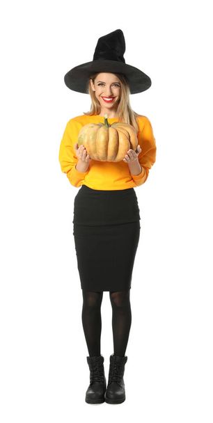 Beautiful woman wearing witch costume with pumpkin for Halloween party on white background - Foto, afbeelding